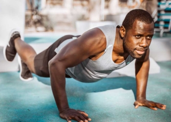 A young man doing a work-out exercise at home